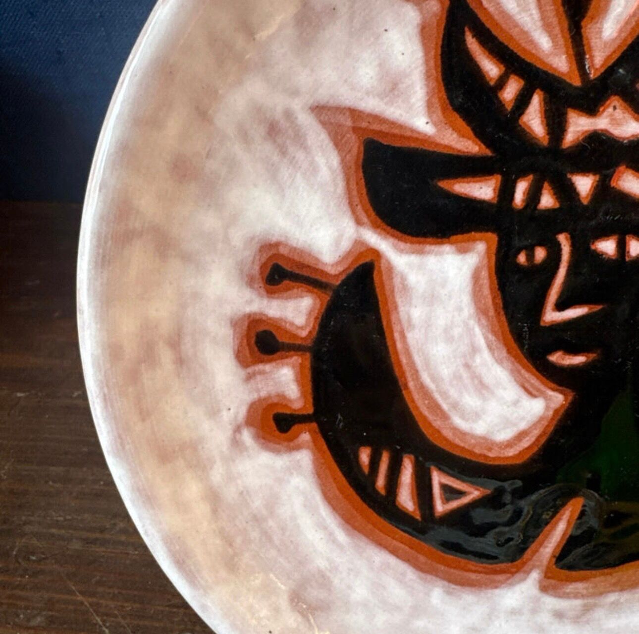 Terracotta plate, Jean Lurçat decorated with a character on a white background.