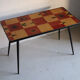 Vintage coffee table in laminate with geometric design, with tapered legs.
