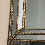 Mirror consisting of multi-faceted mirrors and brass garlands, French work, around 1970