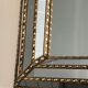 Mirror consisting of multi-faceted mirrors and brass garlands, French work, around 1970