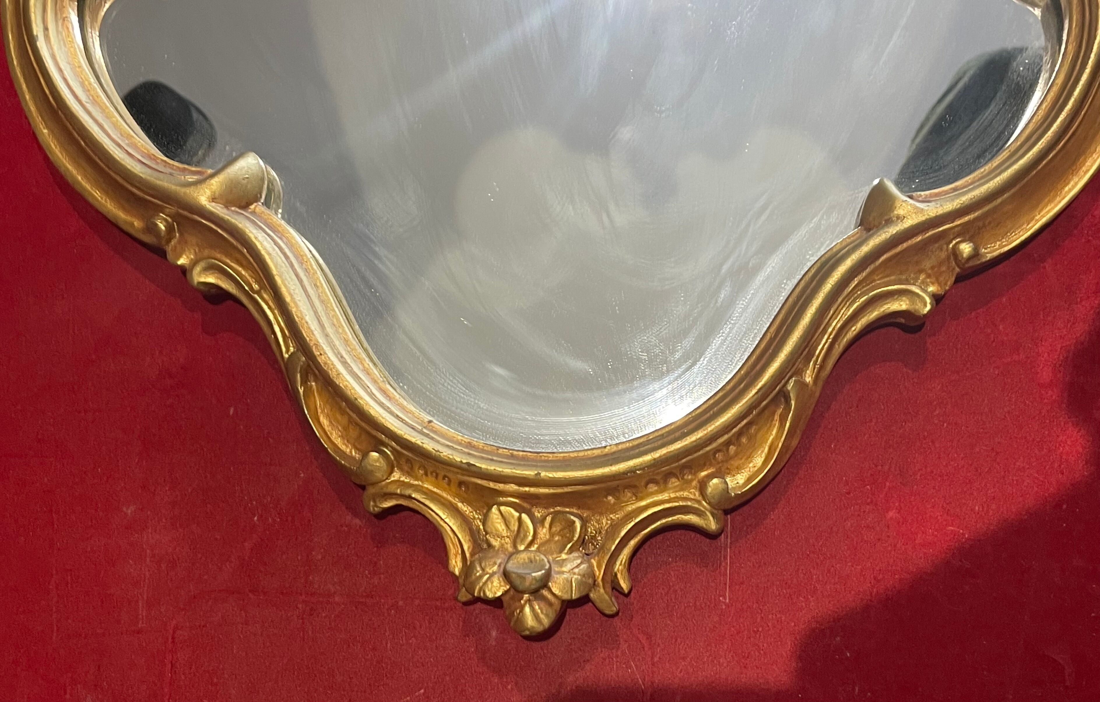 Louis XV Style wood and gilded stucco mirror with animated shape