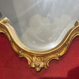 Louis XV Style wood and gilded stucco mirror with animated shape