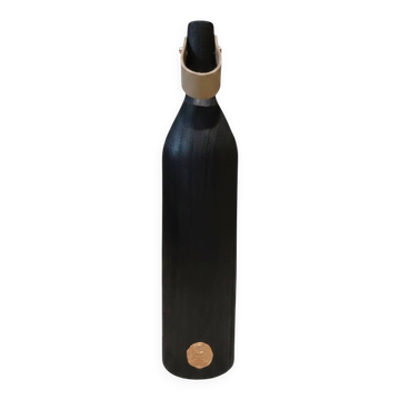 Burnt wood vase for dried flowers, with a leather and brass handle.