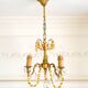 Small vintage brass chandelier with amber crystal pendants.
