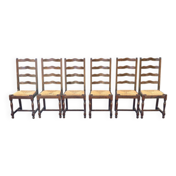 6 solid wood chairs in dark oak with a glossy finish and straw.