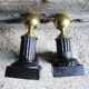 Old cast iron and brass andirons in neoclassical style