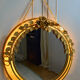 Vintage round illuminated mirror in gold metal with rose decoration.