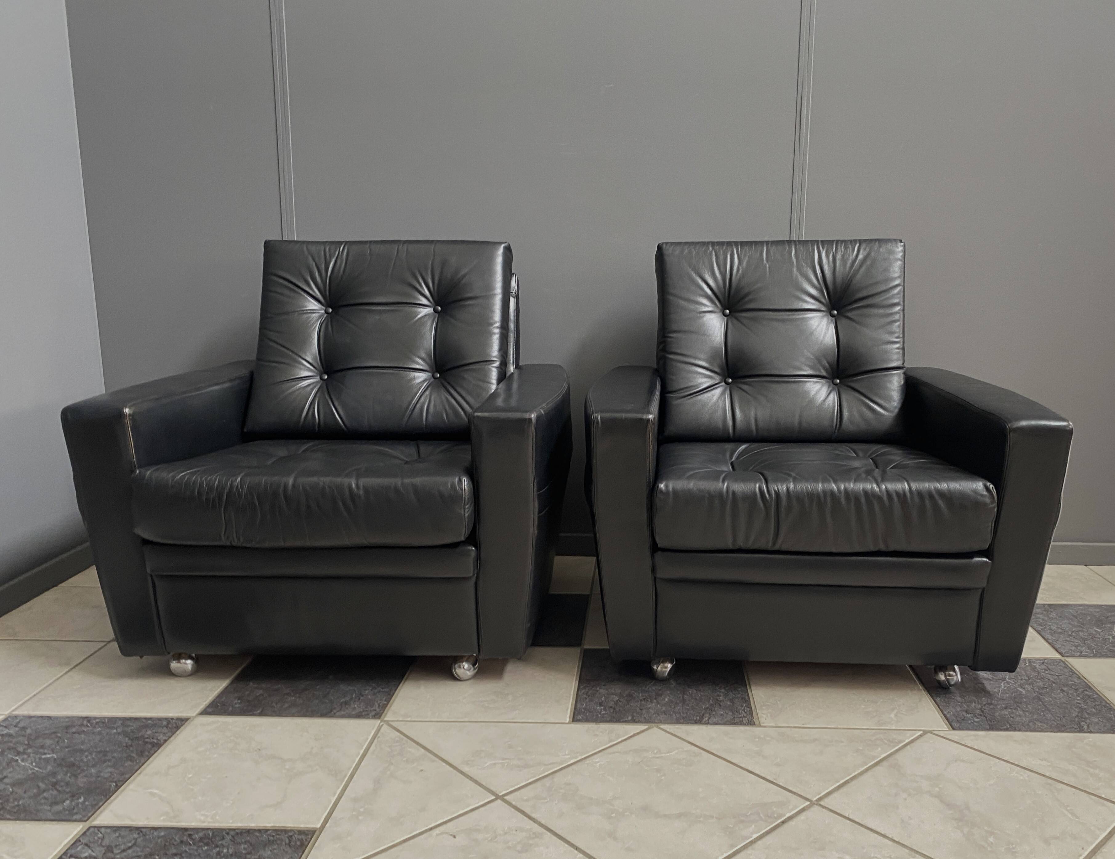 2 Black leather arm chairs 1960s on wheels