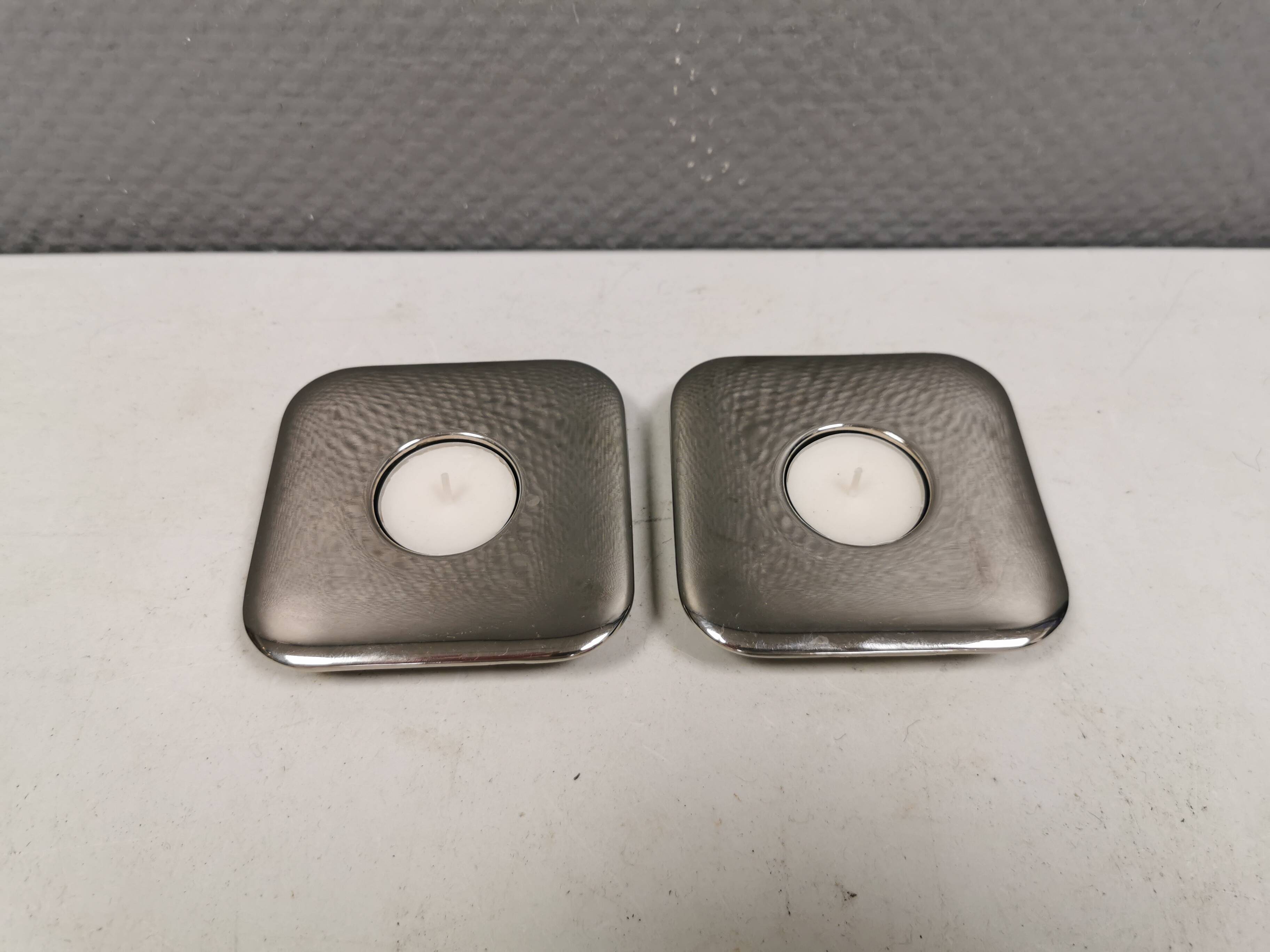 A set of classic Danish candlesticks in polished metal.