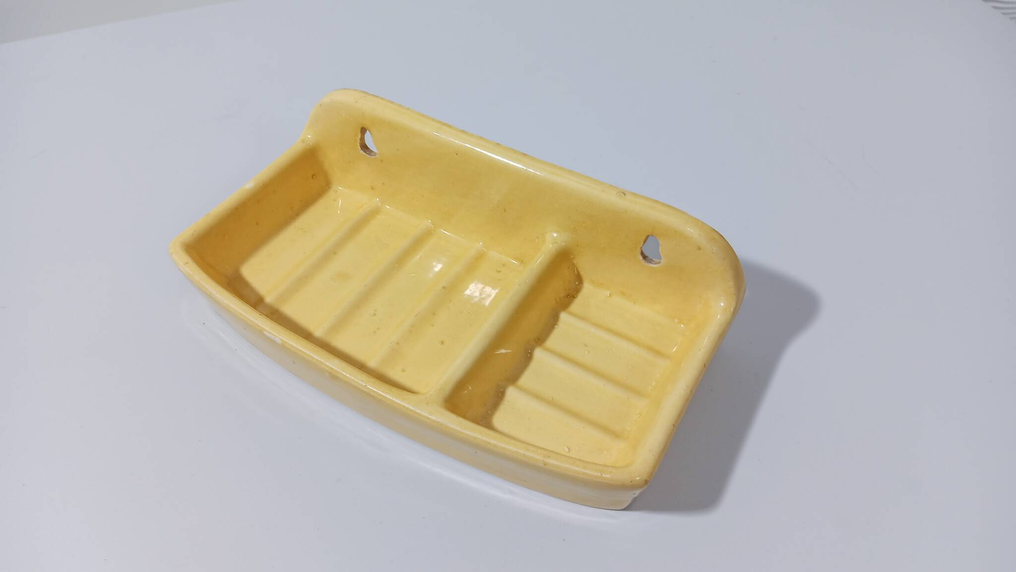 Pale yellow ceramic soap dish