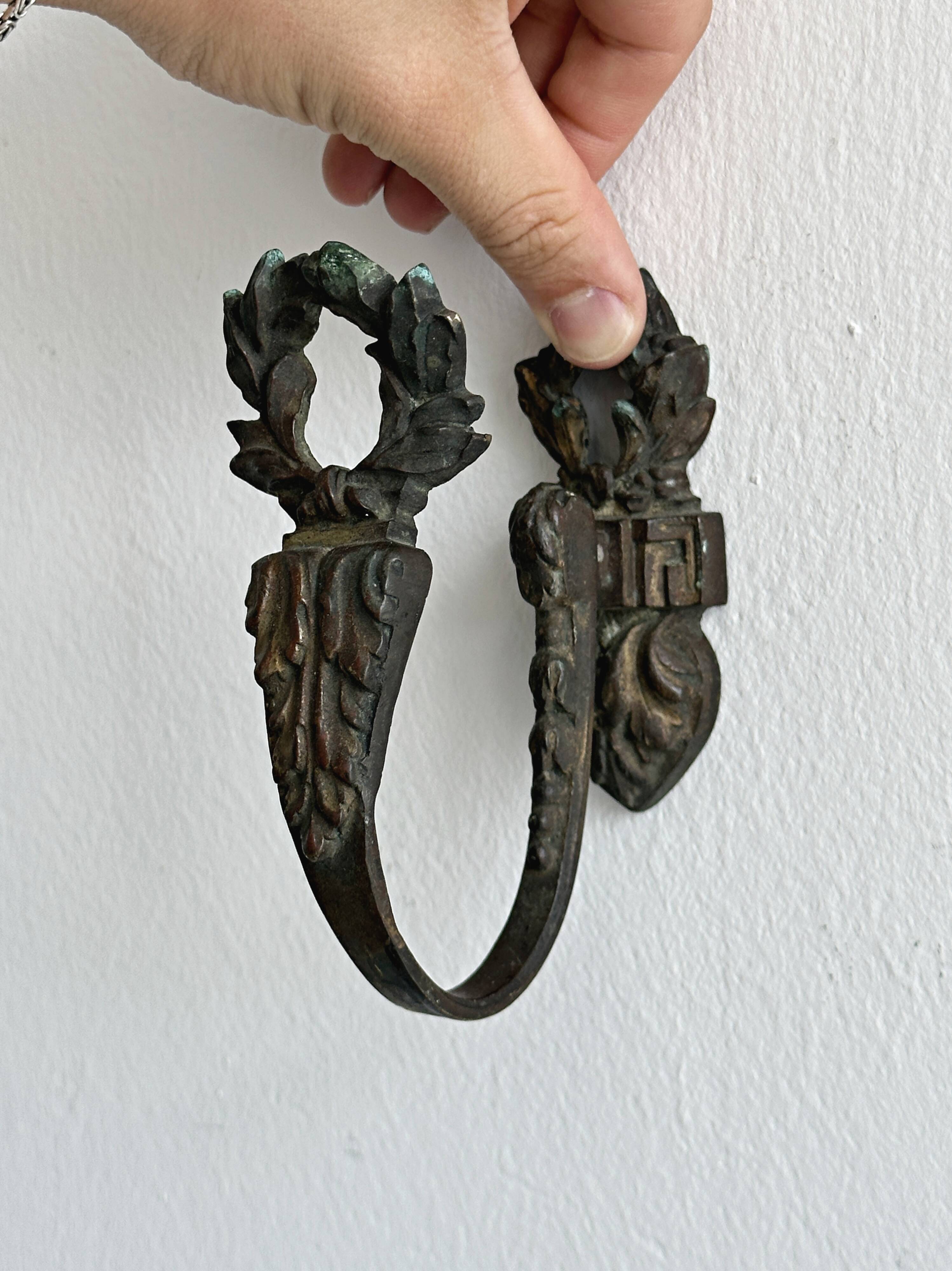 Antique black patinated metal coat hook.