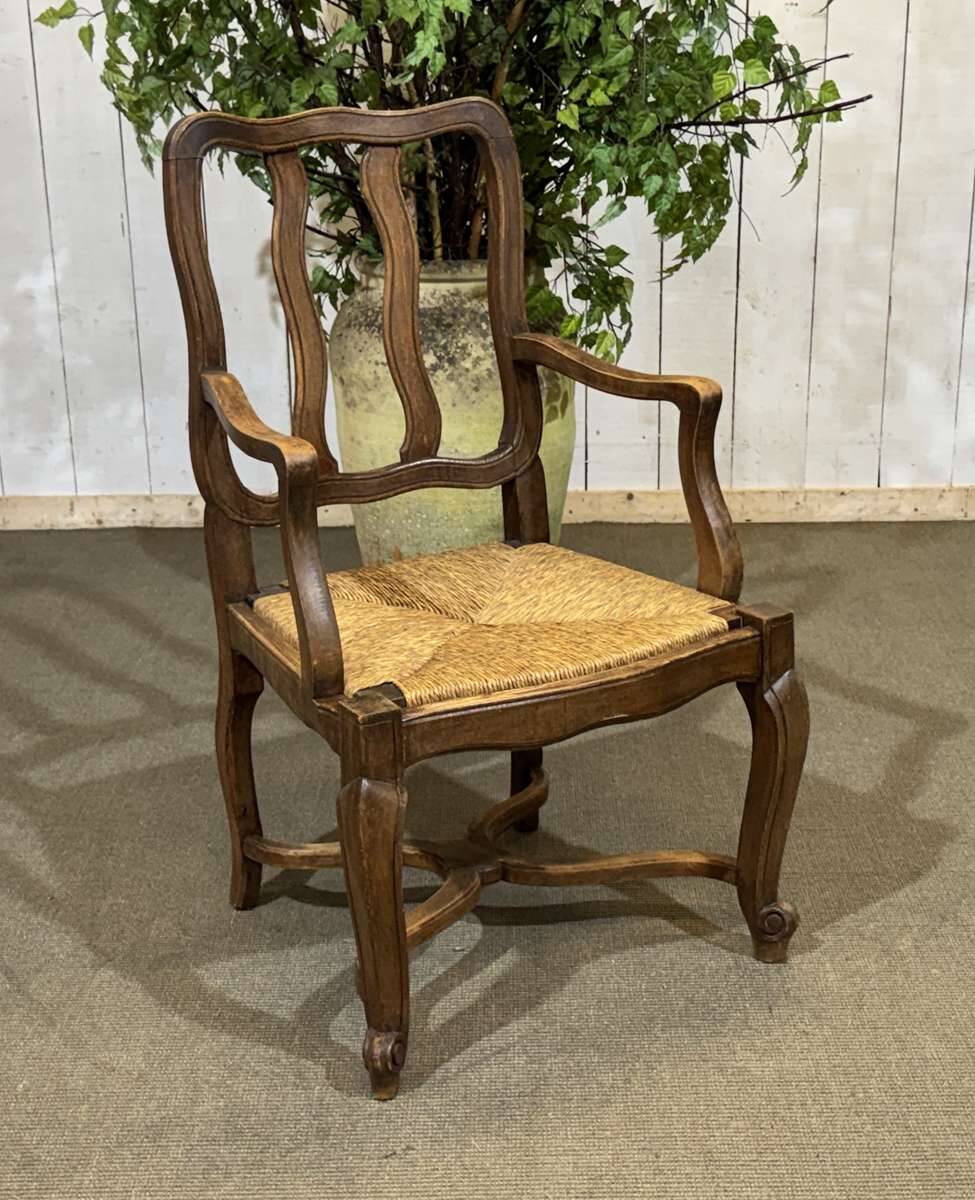 20th-century armchair in beech with a straw seat in Louis XV style.