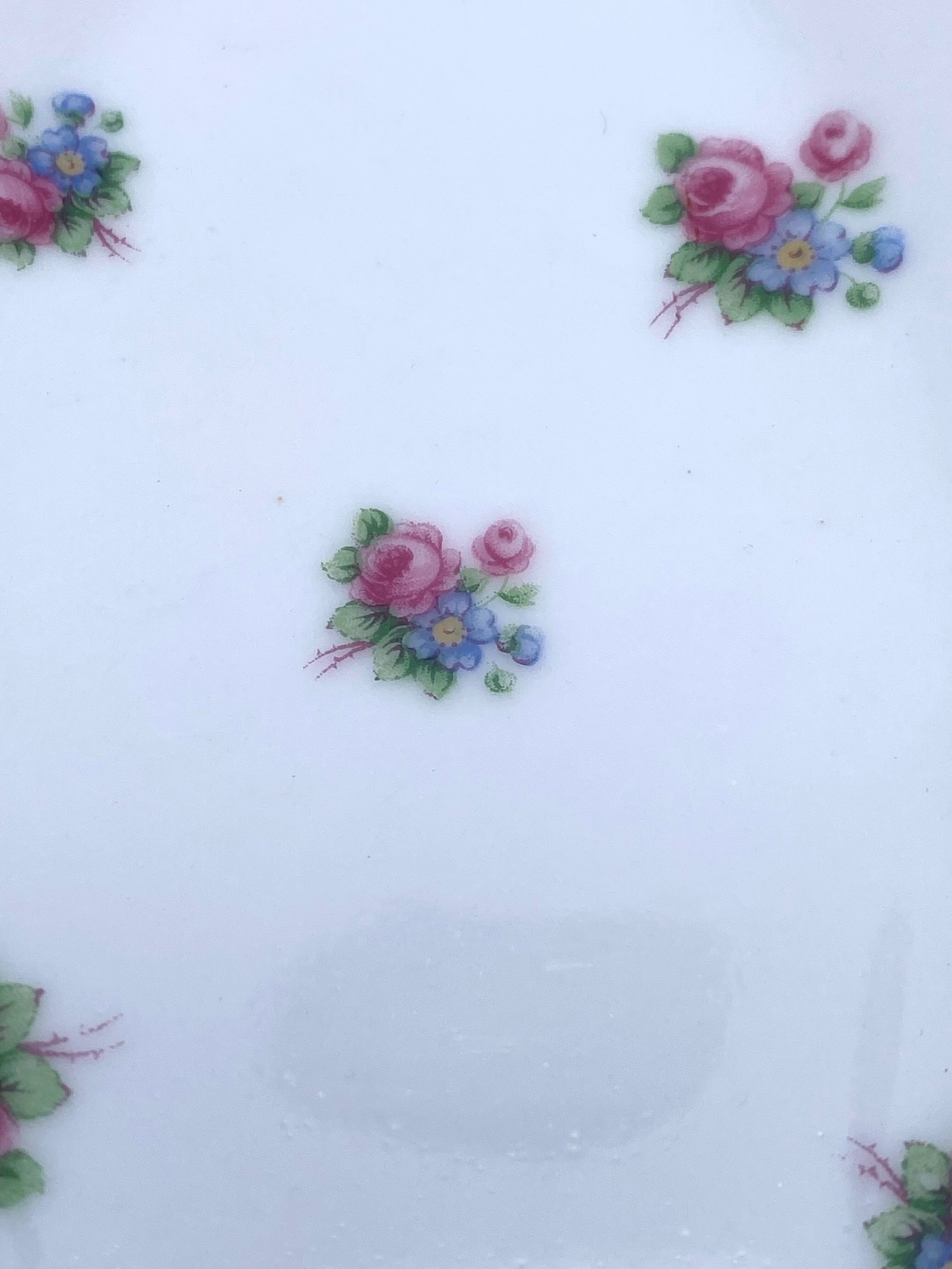 Porcelain serving dishes with small flowers and silver edging and