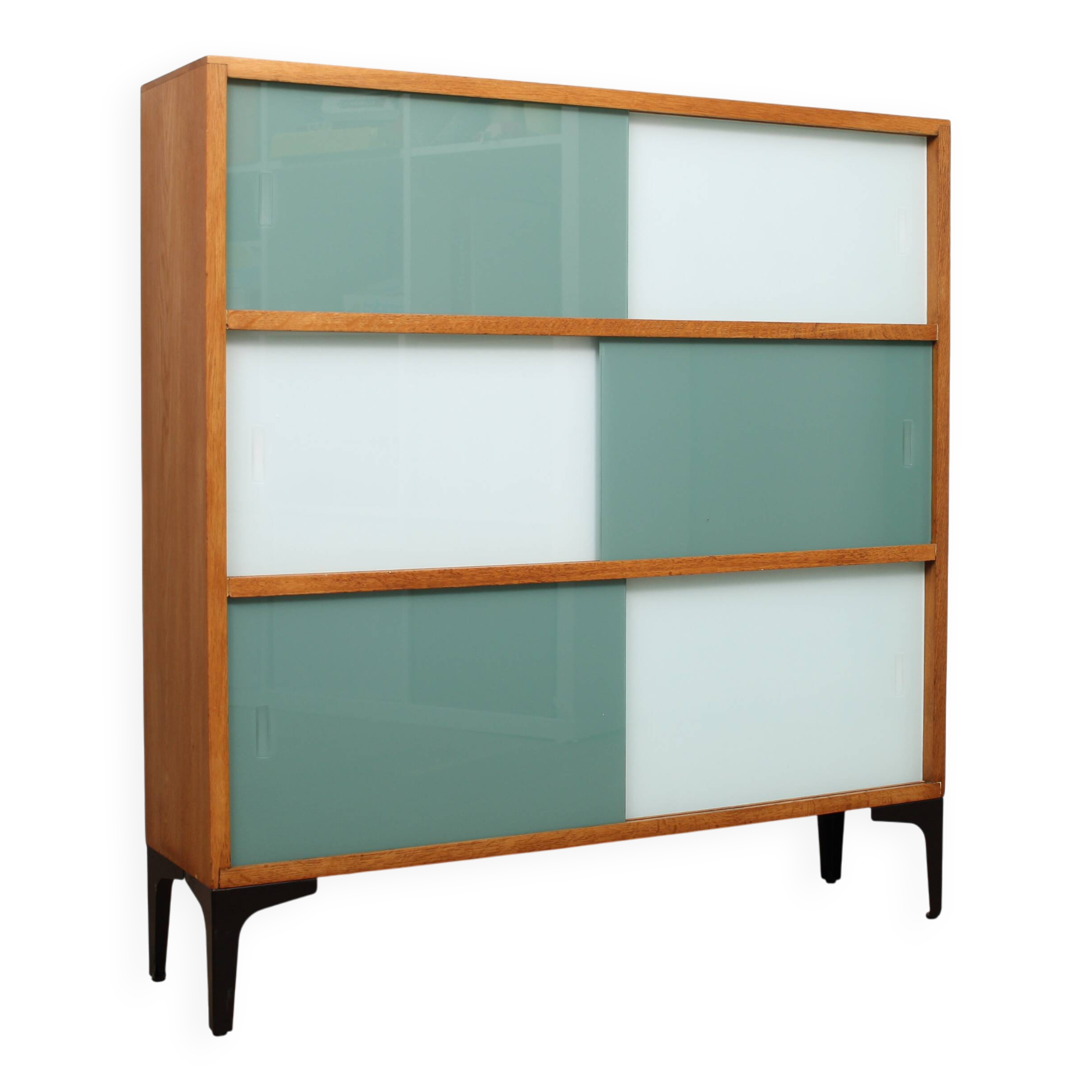 A vintage mid-century 3 tiered bookcase with glass sliding doors