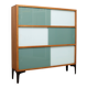 A vintage mid-century 3 tiered bookcase with glass sliding doors