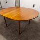 Scandinavian table in round teak with built-in extensions 1960