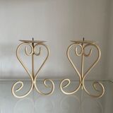 Two beige iron candle holders in a heart shape