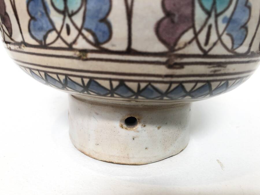 Cup on a ceramic pedestal – blue and turquoise geometric design.