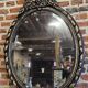 Old black and gold patinated oval mirror louis xv style