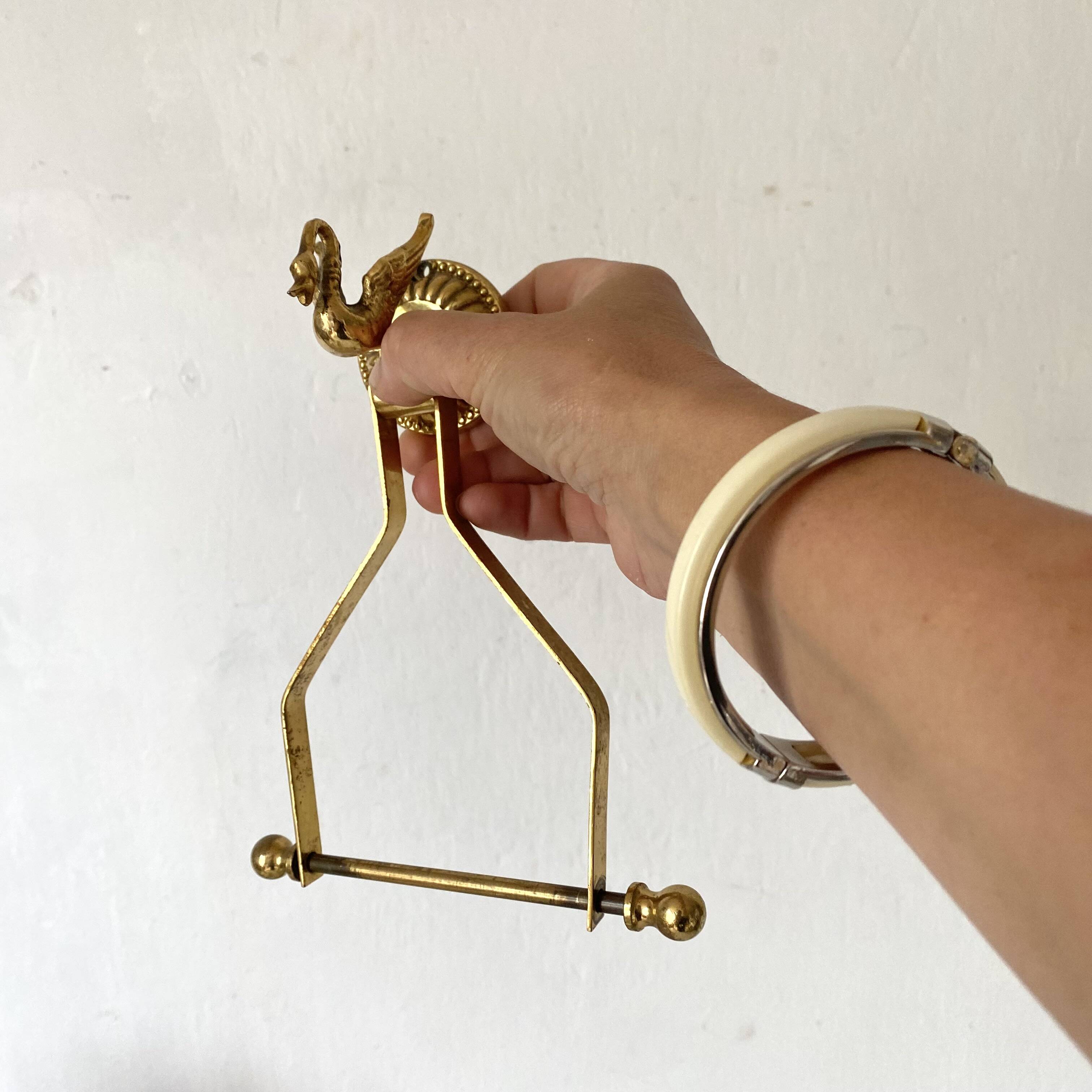 Swan toilet paper dispenser in brass