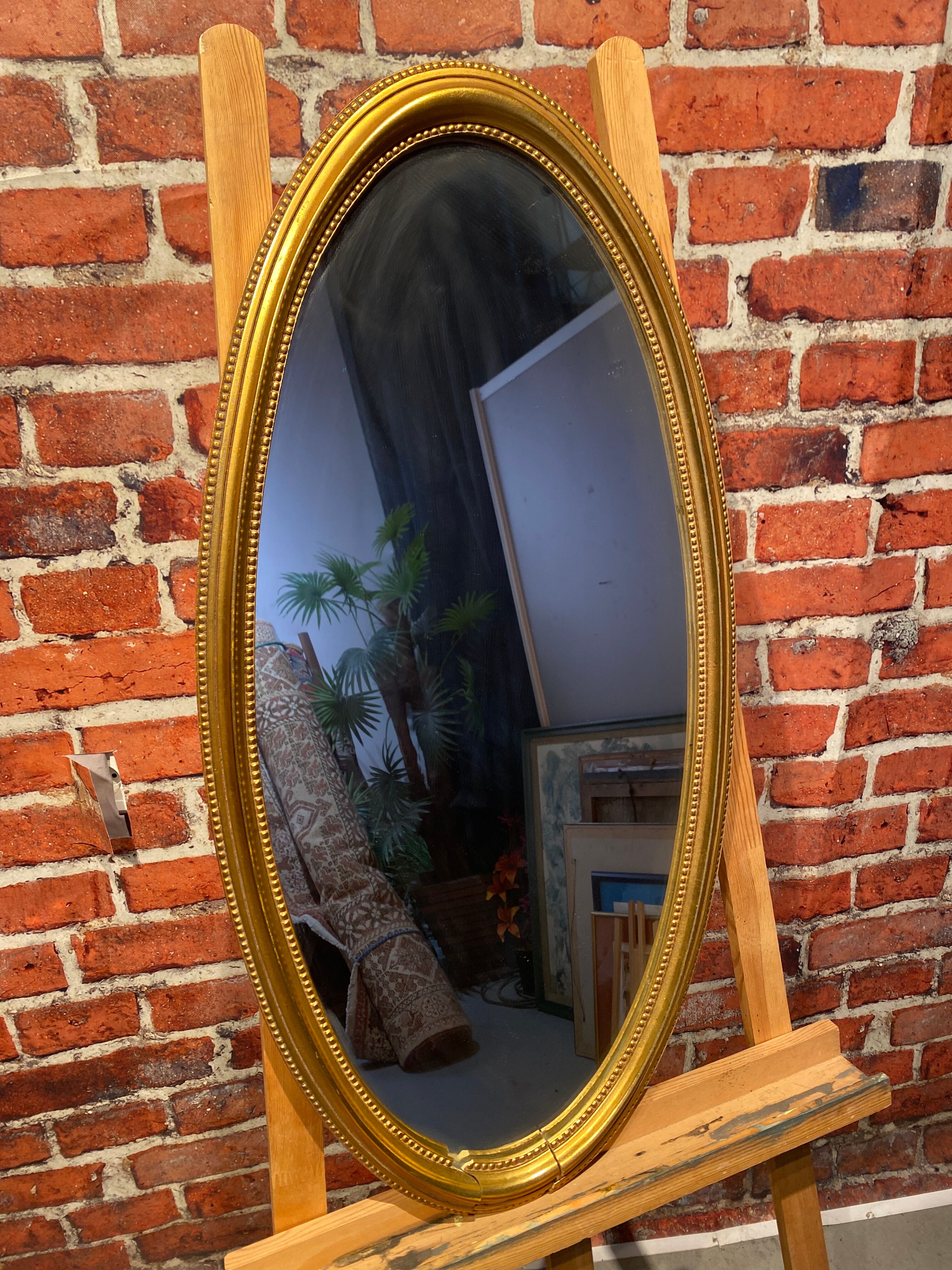 Oval mirror in a frame