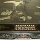 Chinese black wood table inlaid with mother-of-pearl featuring a relief scene of a crane.