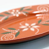 Portuguese XL dish in orange enamelled clay with unbleached flowers and green leaves