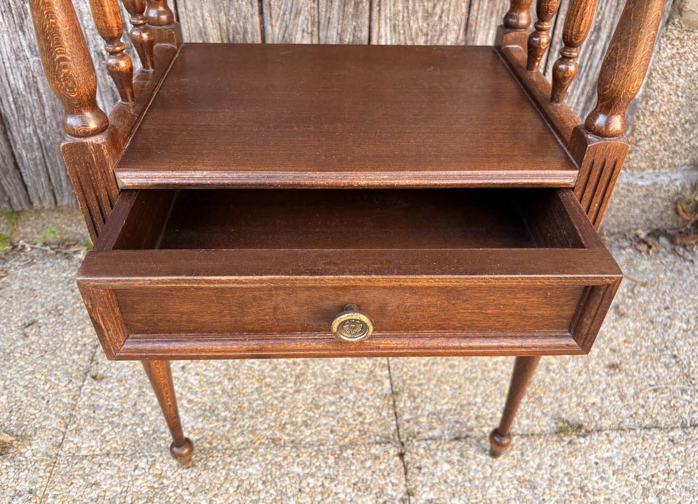 Solid wood bedside table with turned columns, early 20th century.
