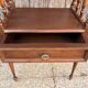 Solid wood bedside table with turned columns, early 20th century.