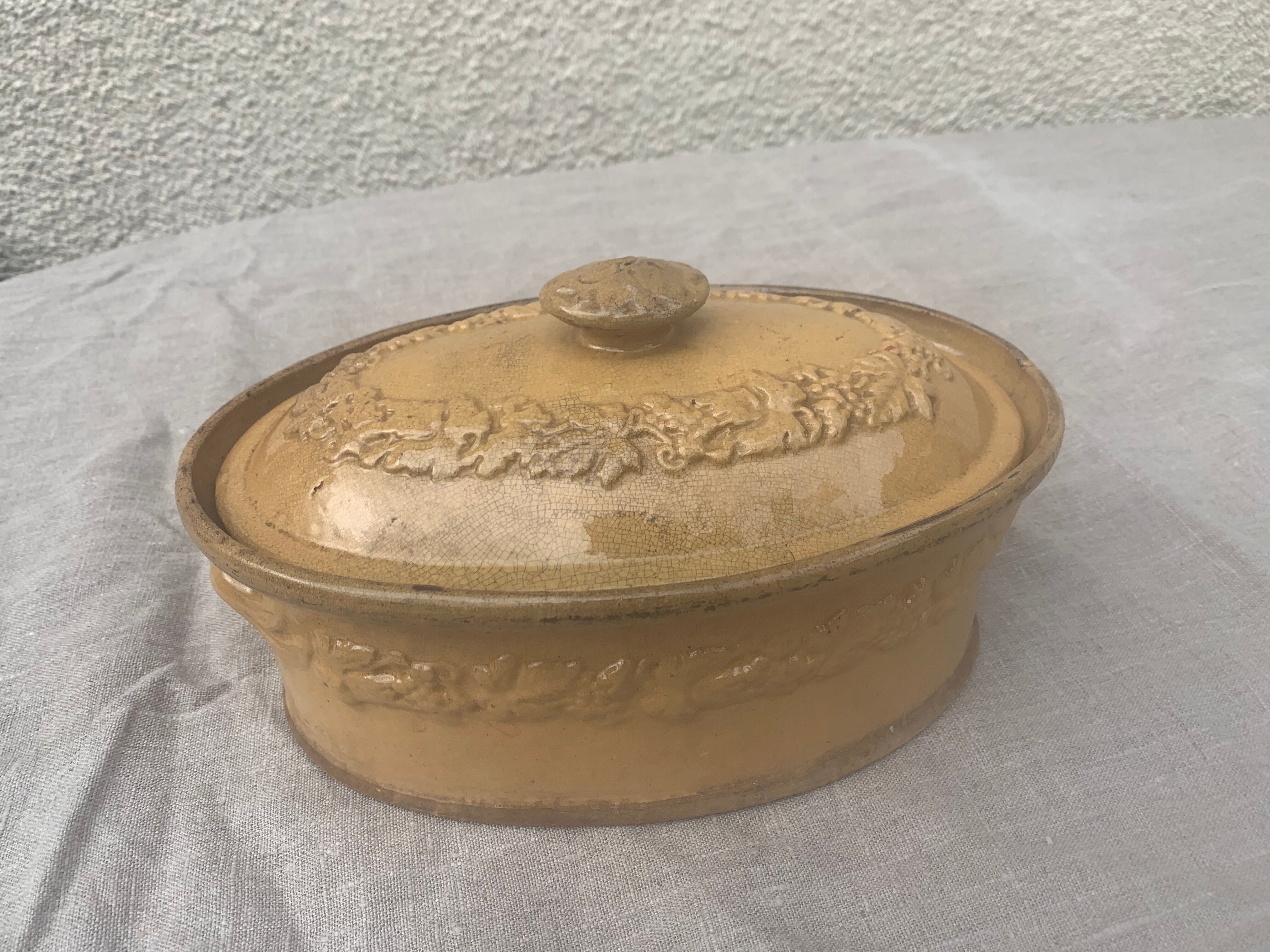 Old terrine in glazed stoneware and floral decoration mustard yellow slip