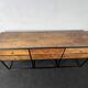 Antique wooden console with black metal base and 6 drawers