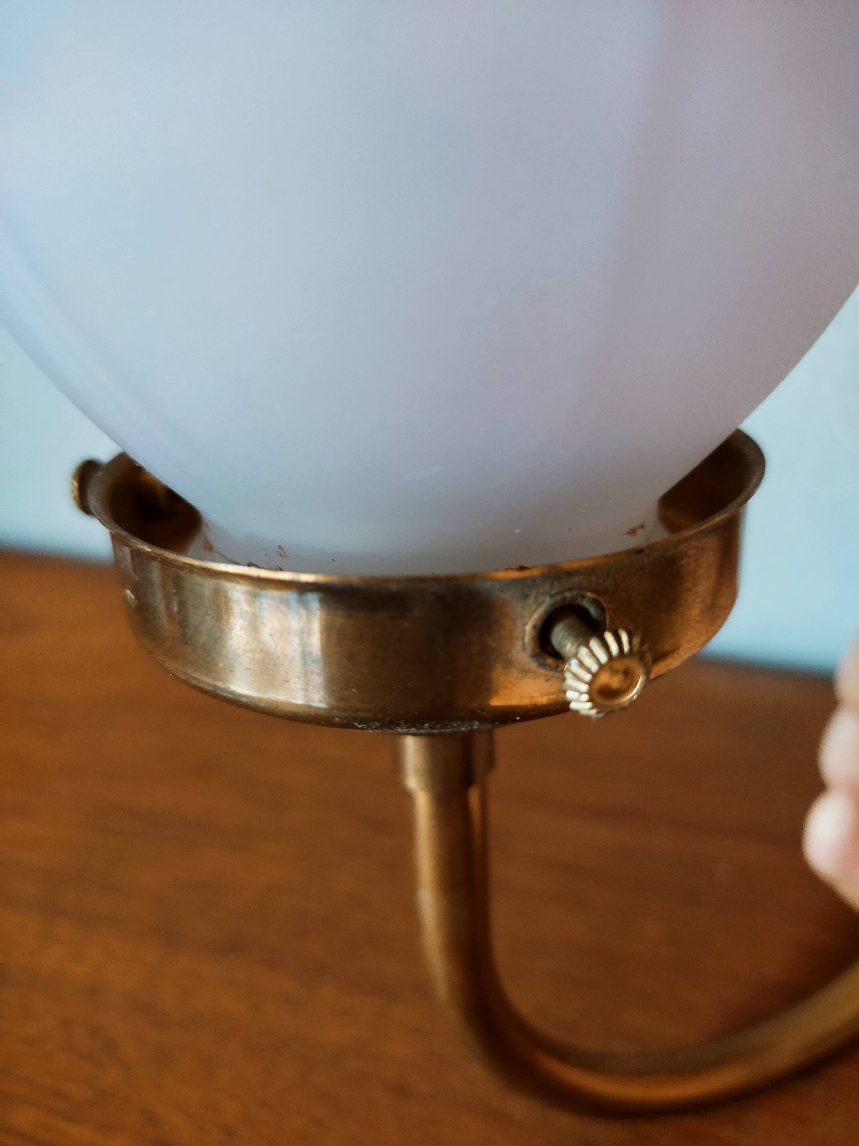 Brass wall lamp with pale pink bell