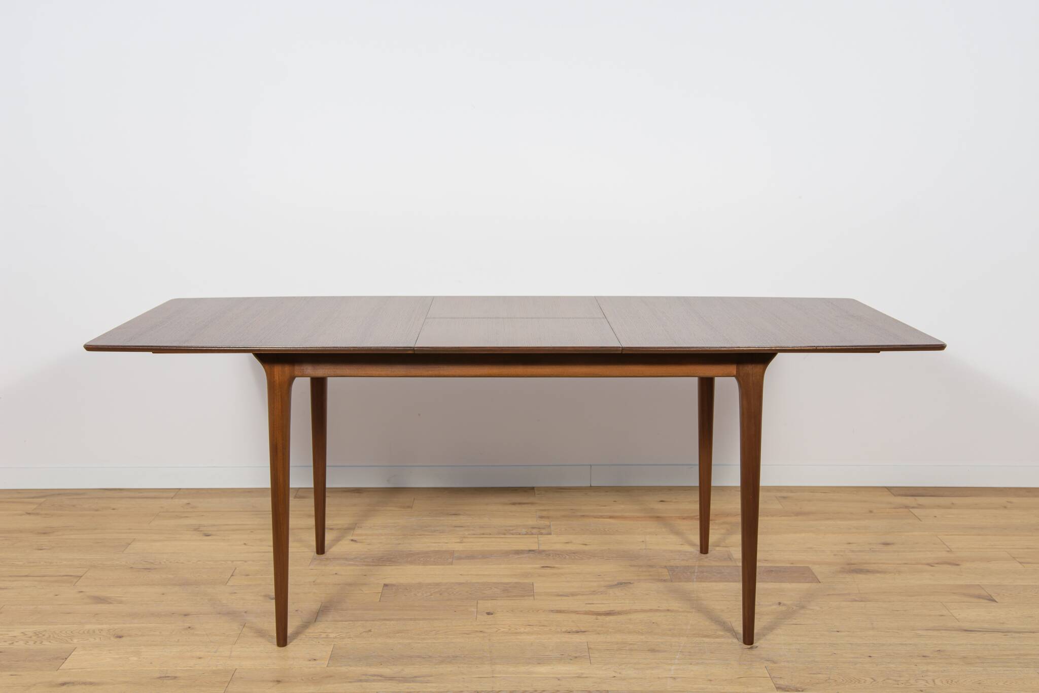 Extendable teak dining table in Mid-Century style from McIntosh, UK.
