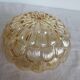ceiling light with amber glass globe, on a round light wood base