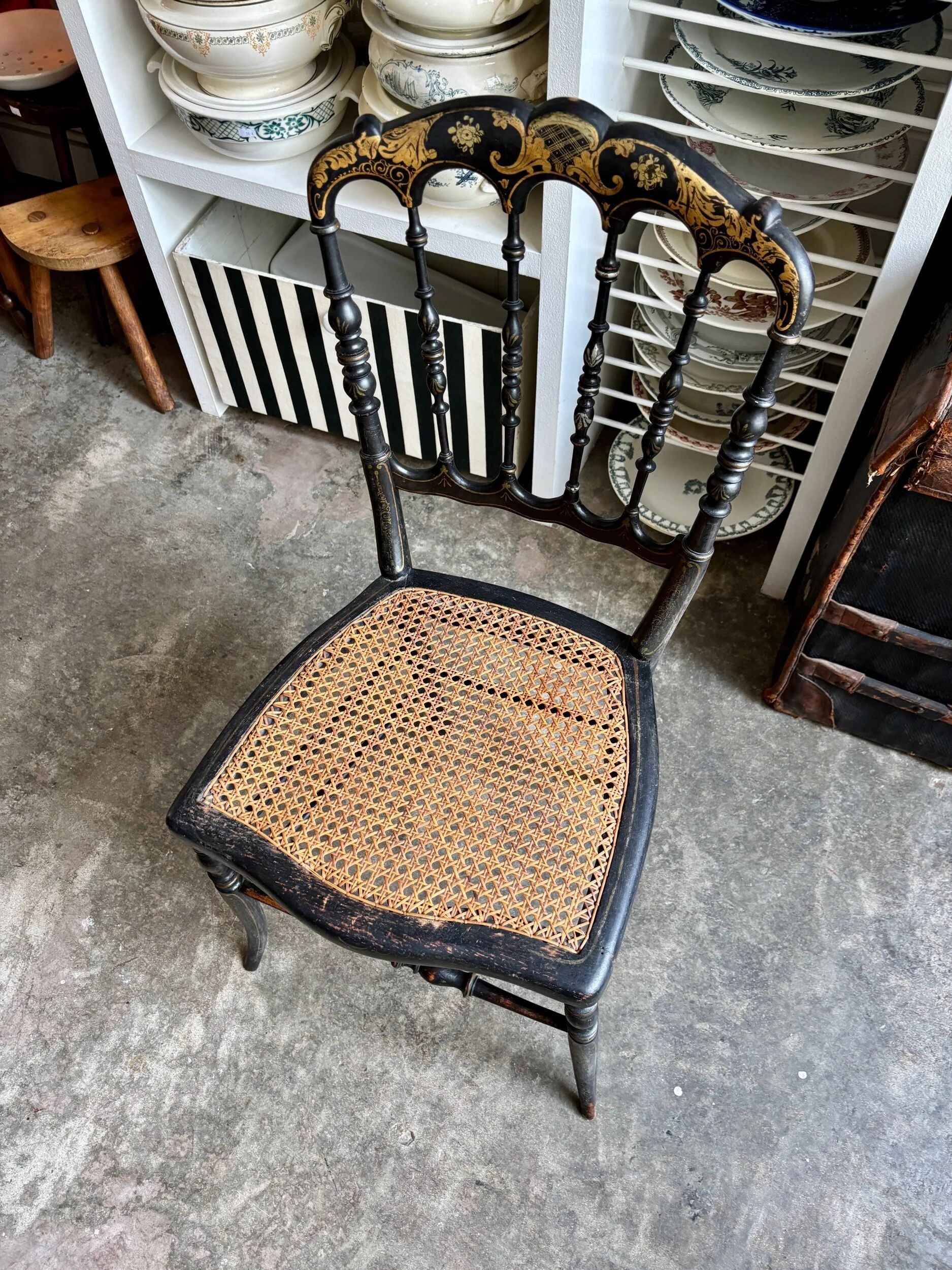Napoleon III chair in black and gold wood with caning.