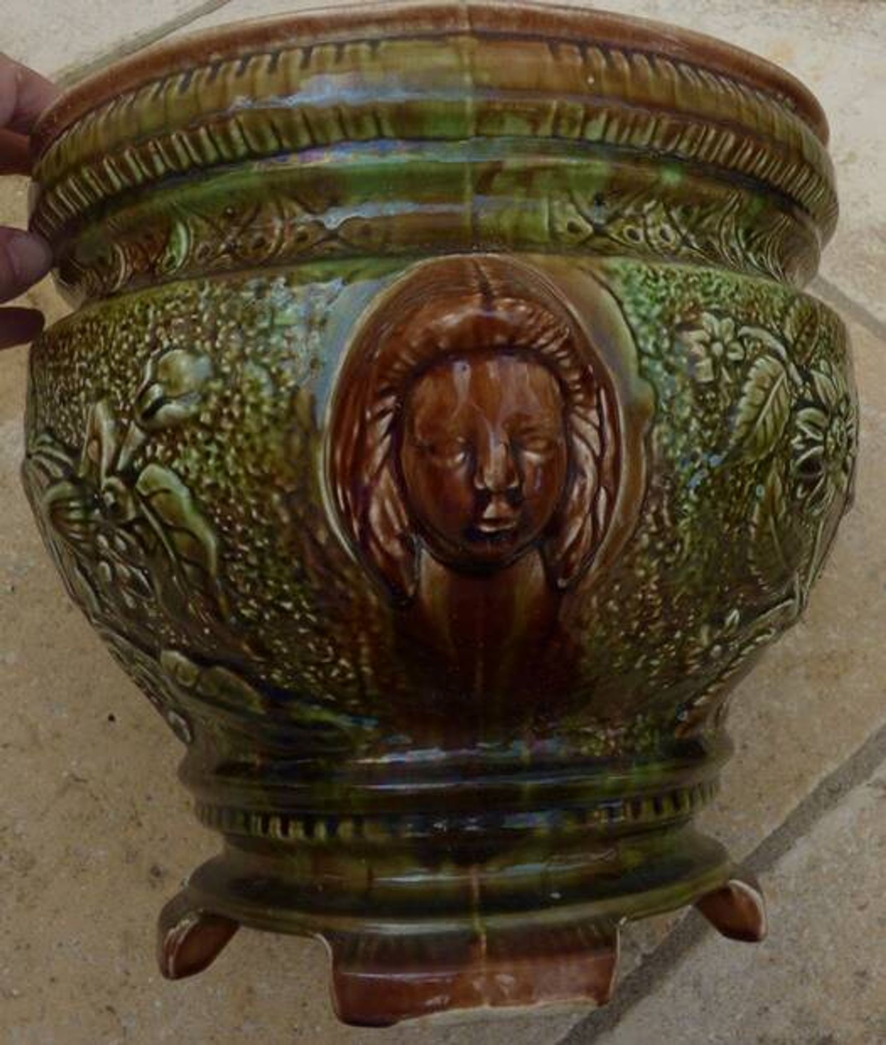 Old earthenware cachepot with woman decoration