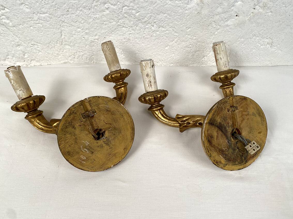Pair of gilded wooden wall lights with two arms, early 20th century.