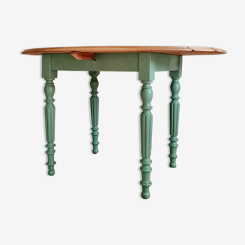Old oval wooden table legs turned green color