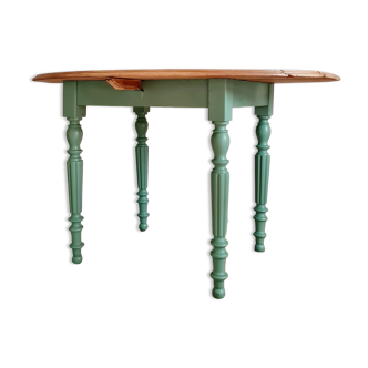 Old oval wooden table legs turned green color