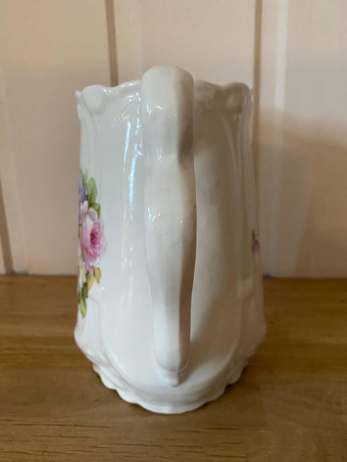 Old ceramic pitcher decorated with flowers