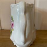 Old ceramic pitcher decorated with flowers