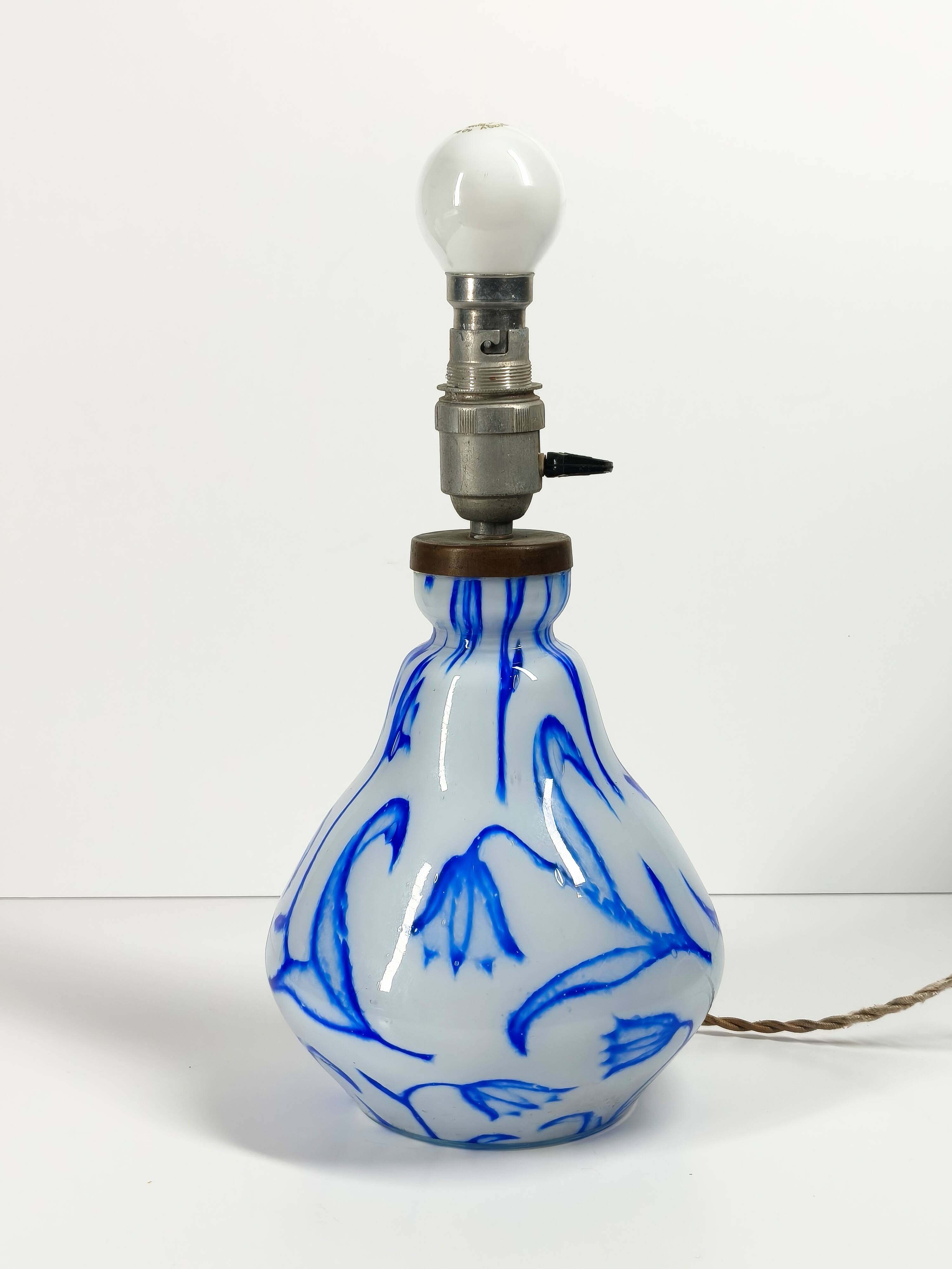 Antique table lamp in opaline glass with blue floral decoration.