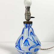 Antique table lamp in opaline glass with blue floral decoration.