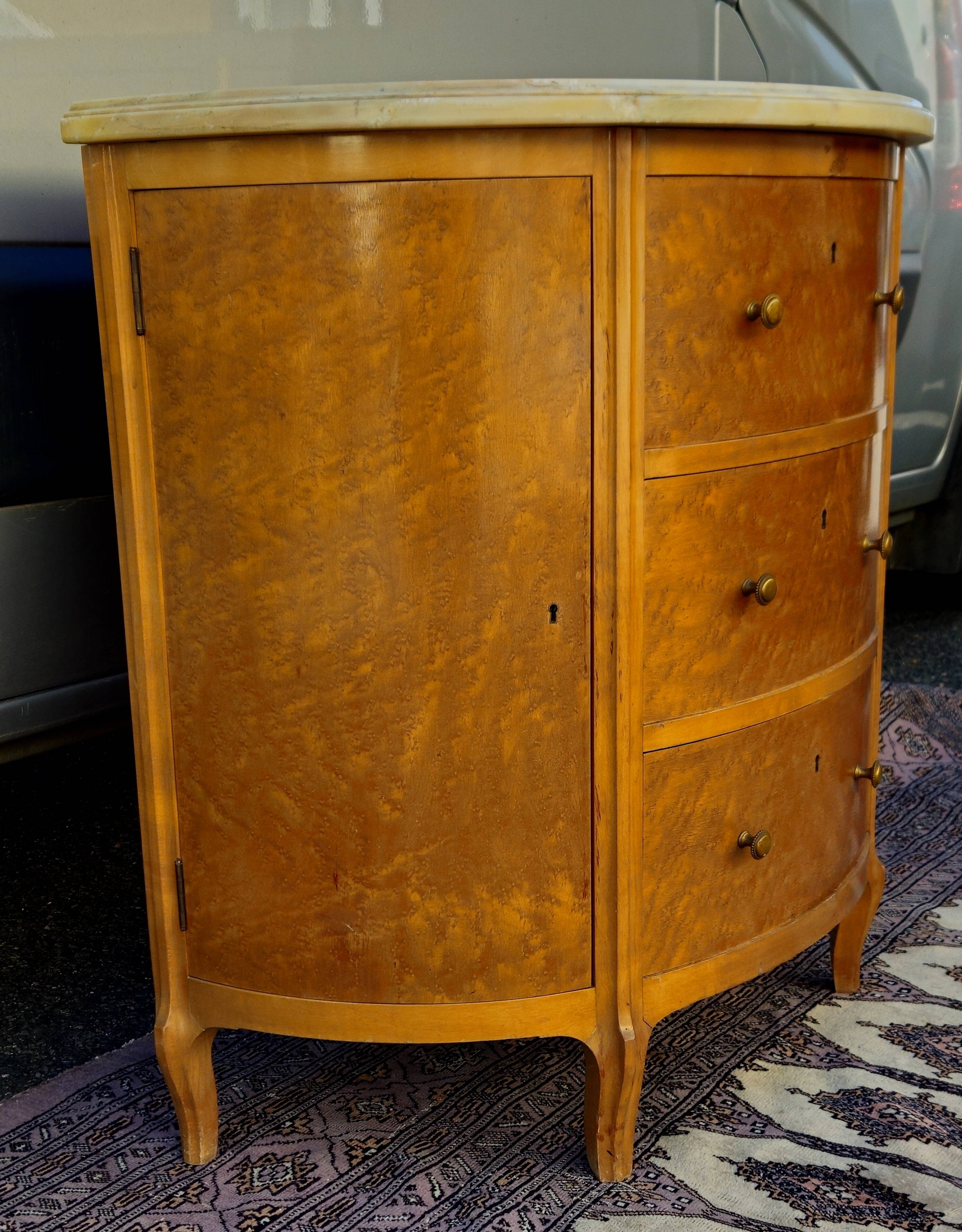 Half-moon commode in burl wood with a marble top.
