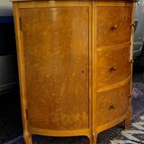 Half-moon commode in burl wood with a marble top.