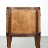 Antique armchair made of sheepskin and wood with decorative nails
