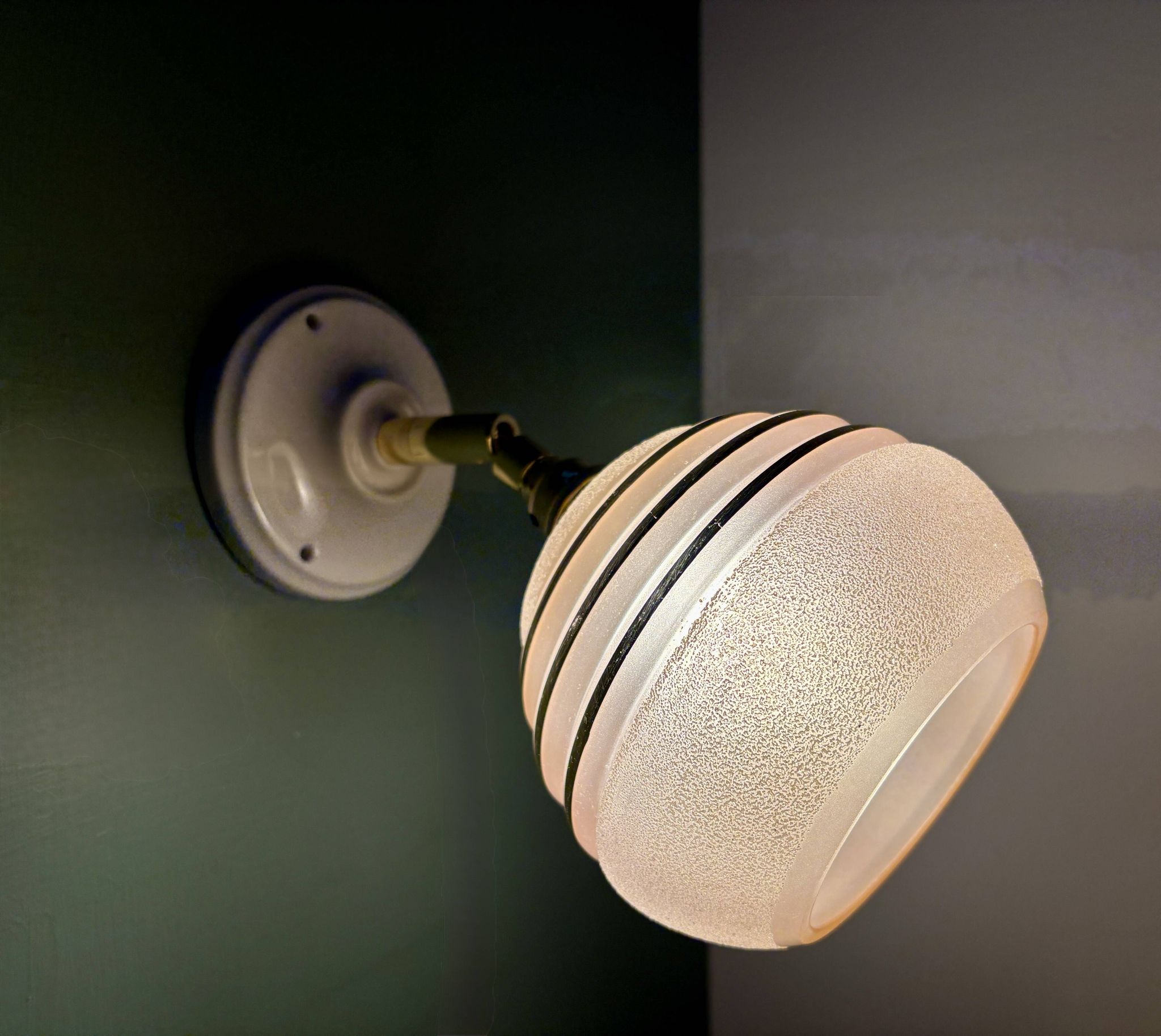 Vintage globe wall light in frosted pink and gold glass.