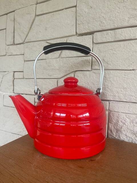 Old red enameled kettle