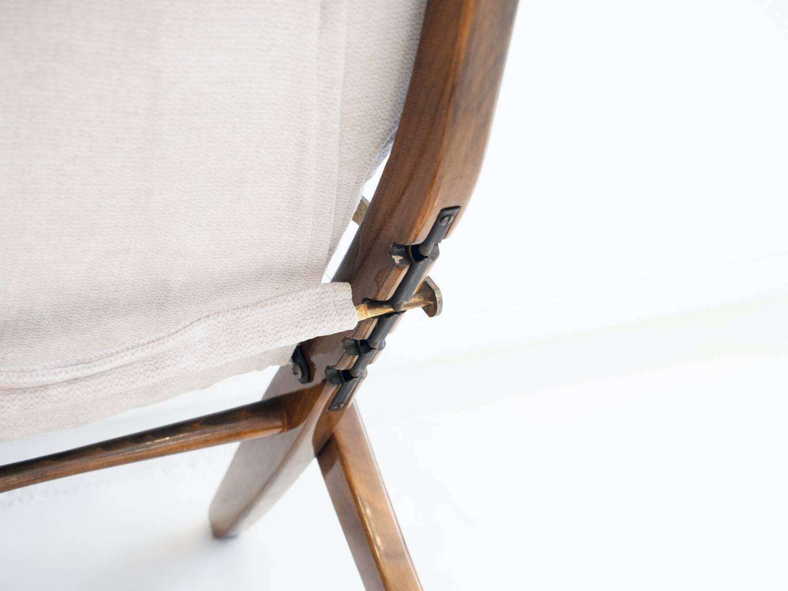 Pair of varnished wooden reclining armchairs, upholstered in lightweight fabric.