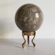 Marble ball paperweight on vintage brass